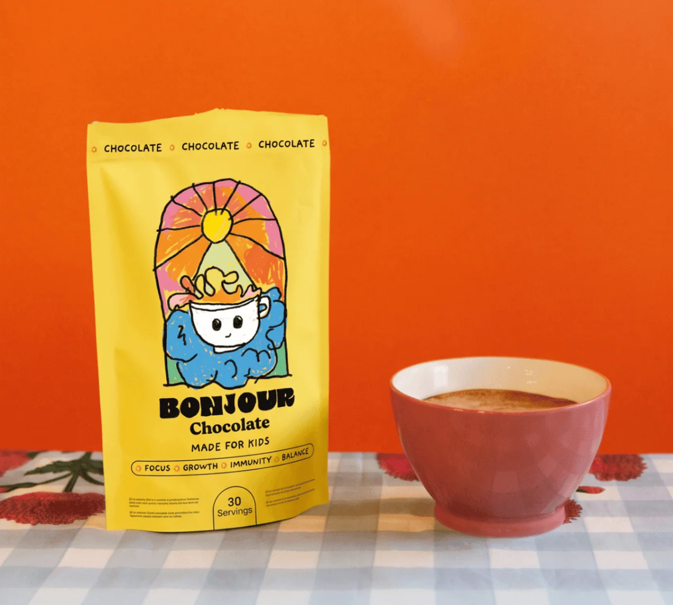 Bonjour Kids Chocolate pouch beside a prepared chocolate drink